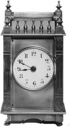 Photograph of a brass carriage clock with a white enamel face